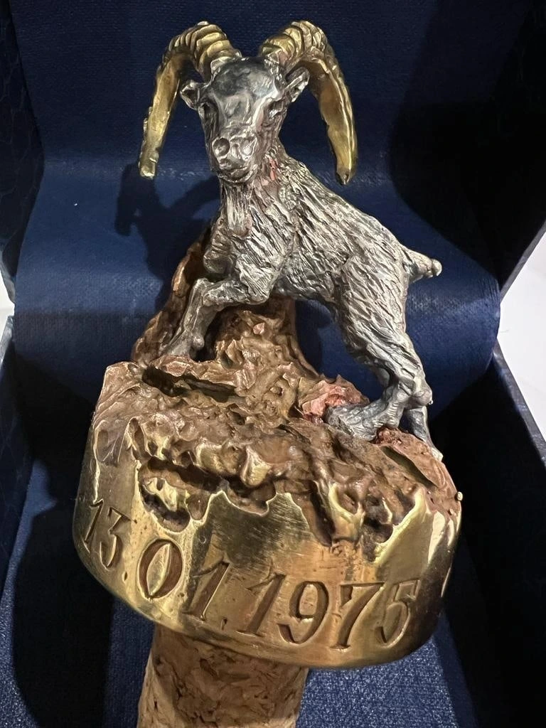 Bronze goat on a wine cork, front view