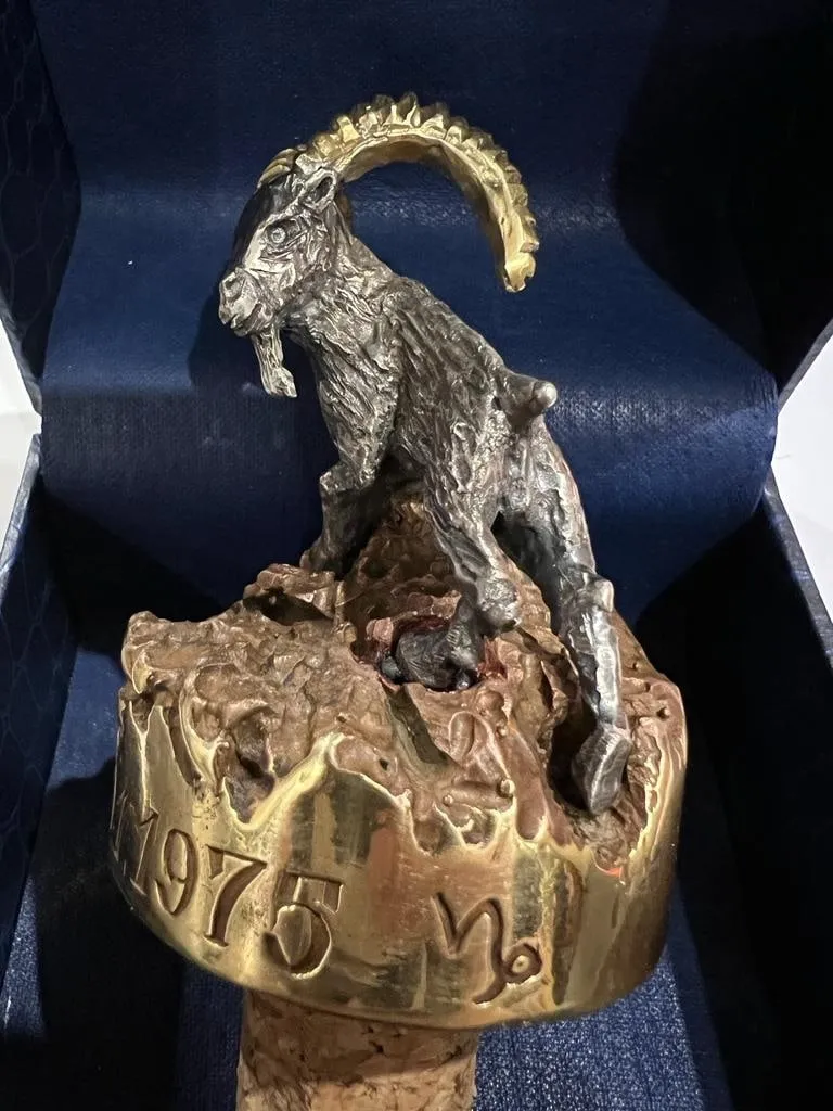 Bronze goat on a wine cork, side view