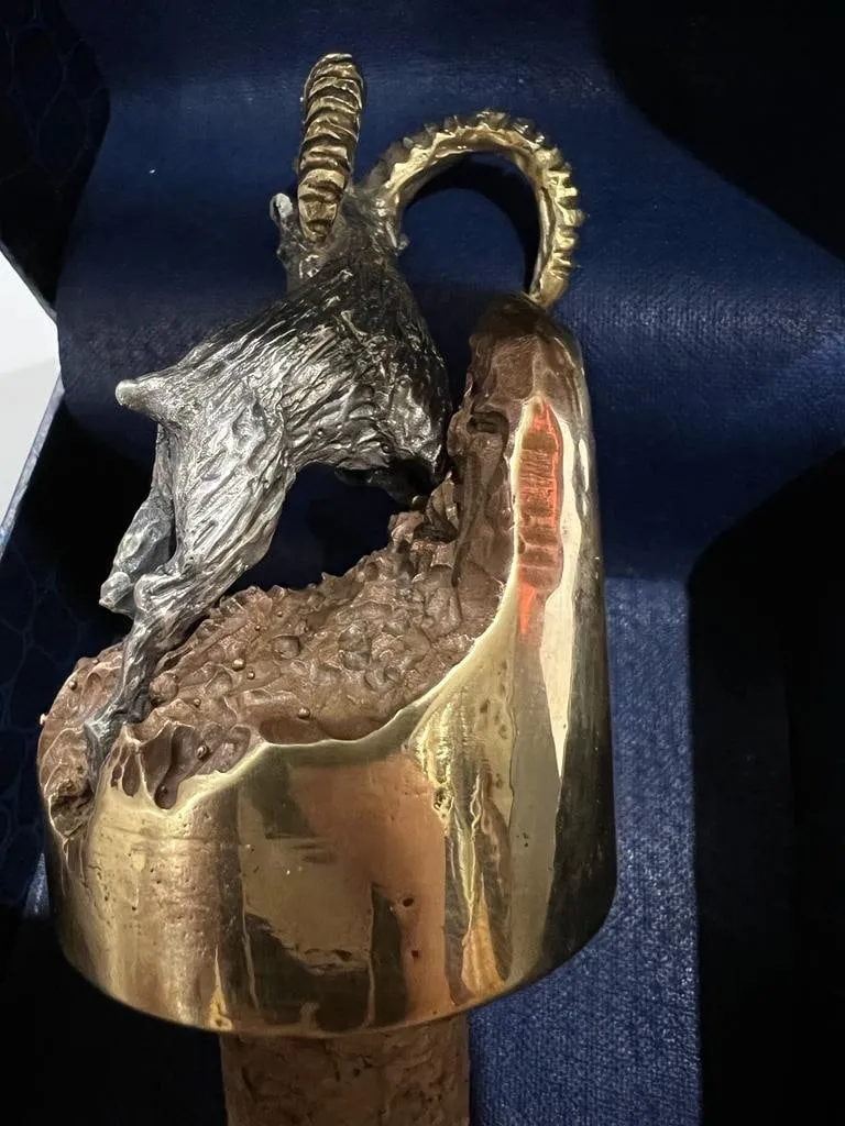 Bronze goat on a wine cork, rear view