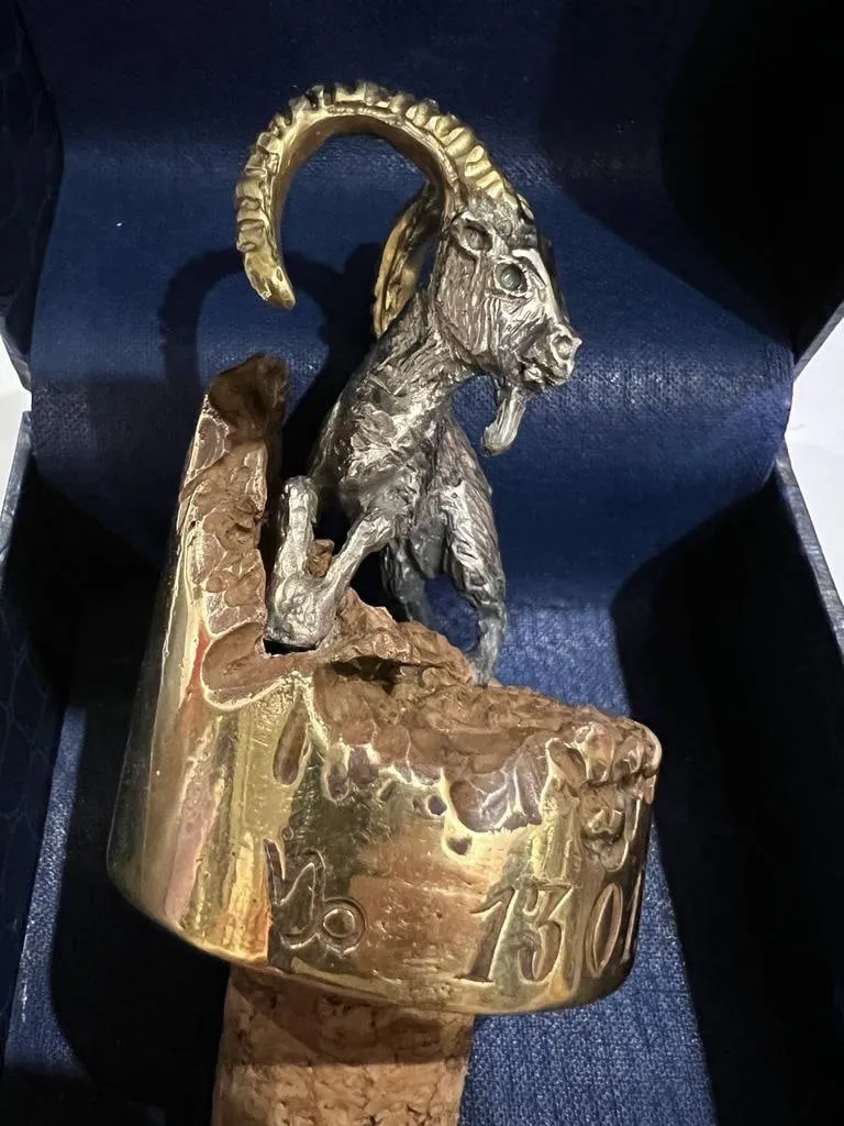 Bronze goat on a wine cork, top view